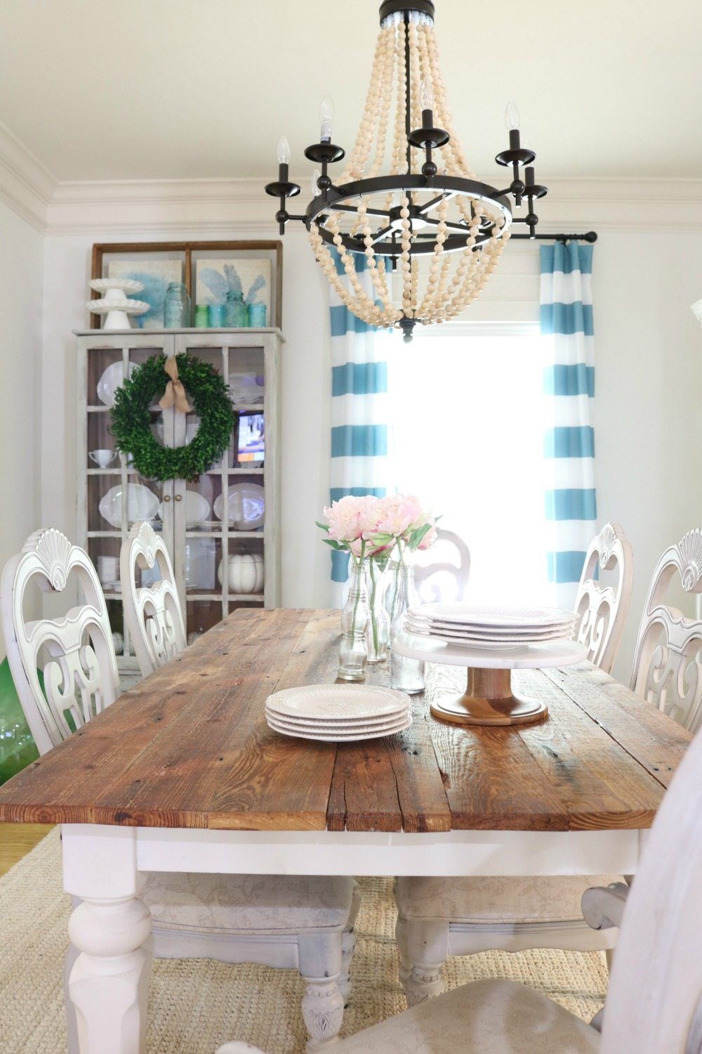 Barnwood table and striped curtains in the dining room