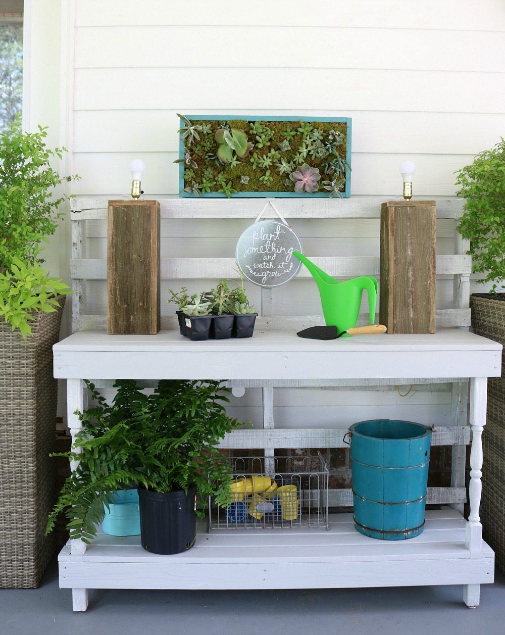 Potting table made from pallets with a vertical succulent garden perfect for the back porch